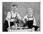 Two brothers sit with Easter decorations, ca. 1948 by Anonymous