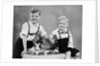 Two brothers sit with Easter decorations, ca. 1948 by Anonymous