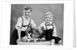 Two brothers sit with Easter decorations, ca. 1948 by Anonymous