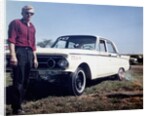 Sixteen year old boy stands with his 1960 Mercury Comet automobile, ca. 1962 by Anonymous