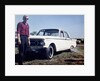 Sixteen year old boy stands with his 1960 Mercury Comet automobile, ca. 1962 by Anonymous