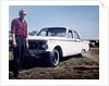 Sixteen year old boy stands with his 1960 Mercury Comet automobile, ca. 1962 by Anonymous