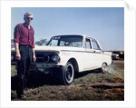 Sixteen year old boy stands with his 1960 Mercury Comet automobile, ca. 1962 by Anonymous