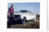 Sixteen year old boy stands with his 1960 Mercury Comet automobile, ca. 1962 by Anonymous