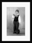 Six year old boy in Bavarian costume holds a pipe, ca. 1947 by Anonymous