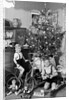 Two brothers are shown with their toys under the Christmas tree in Germany, ca. 1949 by Anonymous