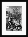 Two brothers are shown with their toys under the Christmas tree in Germany, ca. 1949 by Anonymous
