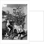 Two brothers are shown with their toys under the Christmas tree in Germany, ca. 1949 by Anonymous