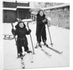 Two brothers stand on their skis in the snow, ca. 1950 by Anonymous