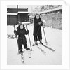 Two brothers stand on their skis in the snow, ca. 1950 by Anonymous