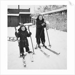 Two brothers stand on their skis in the snow, ca. 1950 by Anonymous