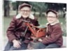 Two brothers play with a Buddy L steam shovel toy in Wisconsin, ca. 1953 by Anonymous