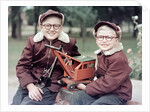 Two brothers play with a Buddy L steam shovel toy in Wisconsin, ca. 1953 by Anonymous