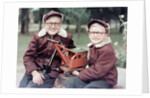 Two brothers play with a Buddy L steam shovel toy in Wisconsin, ca. 1953 by Anonymous