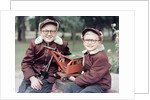 Two brothers play with a Buddy L steam shovel toy in Wisconsin, ca. 1953 by Anonymous