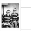 Two brothers pose with a book on their living room couch, ca. 1953 by Anonymous