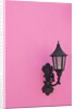 Street lamp on pink wall of Colonial style building by Anonymous