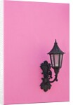 Street lamp on pink wall of Colonial style building by Anonymous