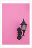 Street lamp on pink wall of Colonial style building by Anonymous
