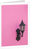 Street lamp on pink wall of Colonial style building by Anonymous