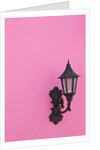 Street lamp on pink wall of Colonial style building by Anonymous