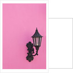 Street lamp on pink wall of Colonial style building by Anonymous