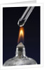 Test tube with liquid, over flame by Anonymous