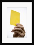 Hand holding yellow card by Anonymous