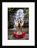 Woman meditating in front of a waterfall by Anonymous