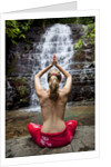 Woman meditating in front of a waterfall by Anonymous