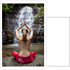 Woman meditating in front of a waterfall by Anonymous