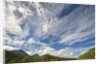 Cumulus and cirrus clouds above mountains by Anonymous