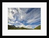 Cumulus and cirrus clouds above mountains by Anonymous