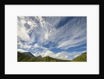 Cumulus and cirrus clouds above mountains by Anonymous