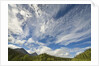 Cumulus and cirrus clouds above mountains by Anonymous