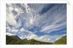Cumulus and cirrus clouds above mountains by Anonymous