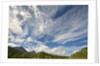 Cumulus and cirrus clouds above mountains by Anonymous