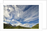 Cumulus and cirrus clouds above mountains by Anonymous
