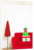 Stack of Christmas gifts on sofa by Anonymous