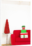 Stack of Christmas gifts on sofa by Anonymous