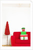 Stack of Christmas gifts on sofa by Anonymous