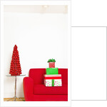 Stack of Christmas gifts on sofa by Anonymous