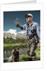 Man fly fishing with dog by Anonymous
