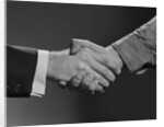 Close-up handshake between businessman and laborer by Anonymous