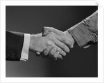 Close-up handshake between businessman and laborer by Anonymous