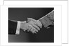 Close-up handshake between businessman and laborer by Anonymous