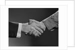 Close-up handshake between businessman and laborer by Anonymous