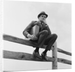 Businessman sitting on fence worried expression holding briefcase by Anonymous