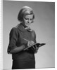 Blond woman secretary teacher taking notes by Anonymous