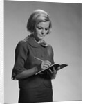 Blond woman secretary teacher taking notes by Anonymous